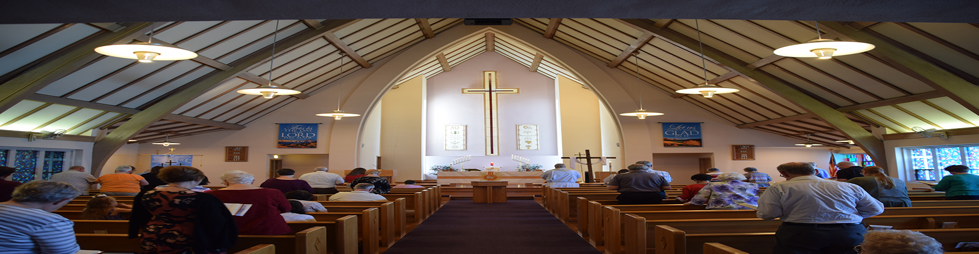 People standing and singing at a church service